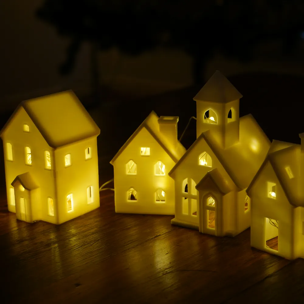 Vila de Natal em miniatura com casinhas iluminadas por dentro